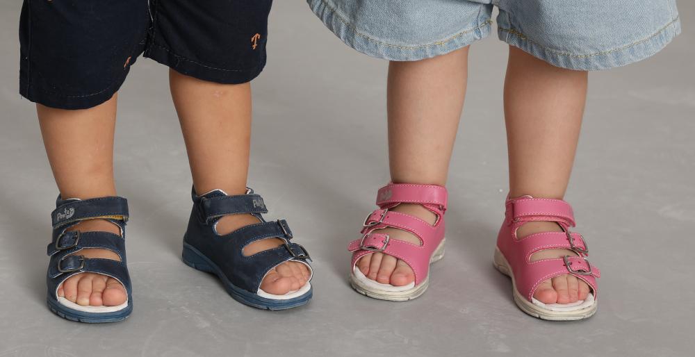image of the feet of a little boy and a girl wearing very comfortable sandals.
