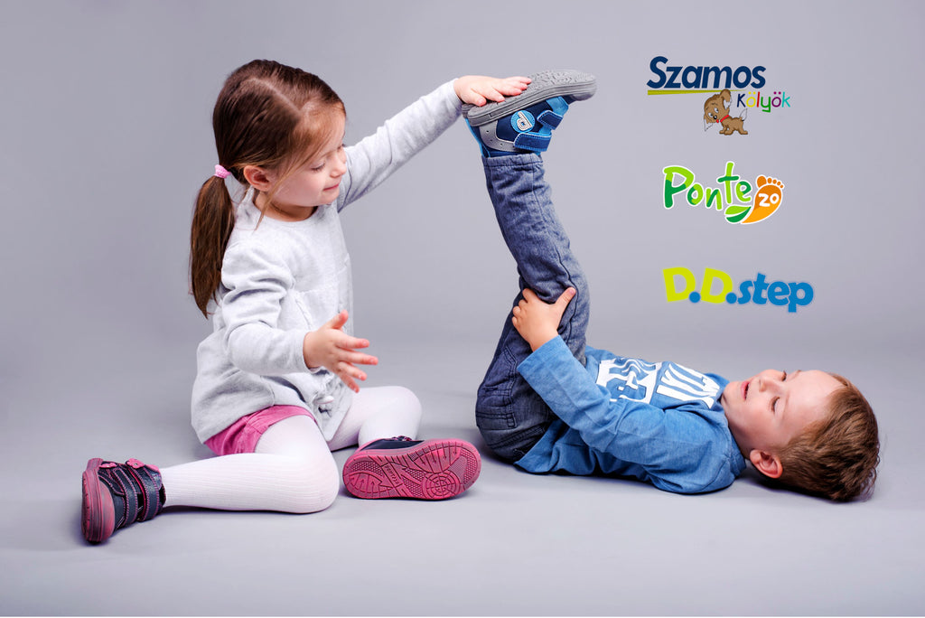 girl_and_boy_playing_together_showing_off_their_shoes